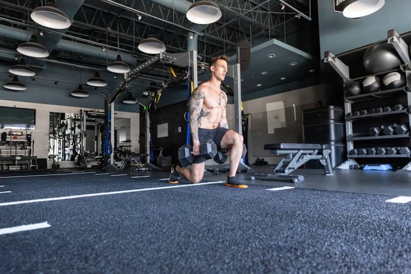 A man with no shirt in a gym