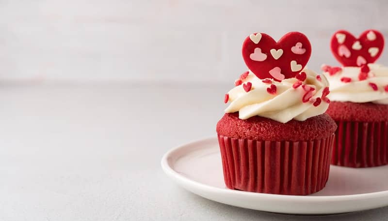 Red velvet cupcakes with heart decorations.