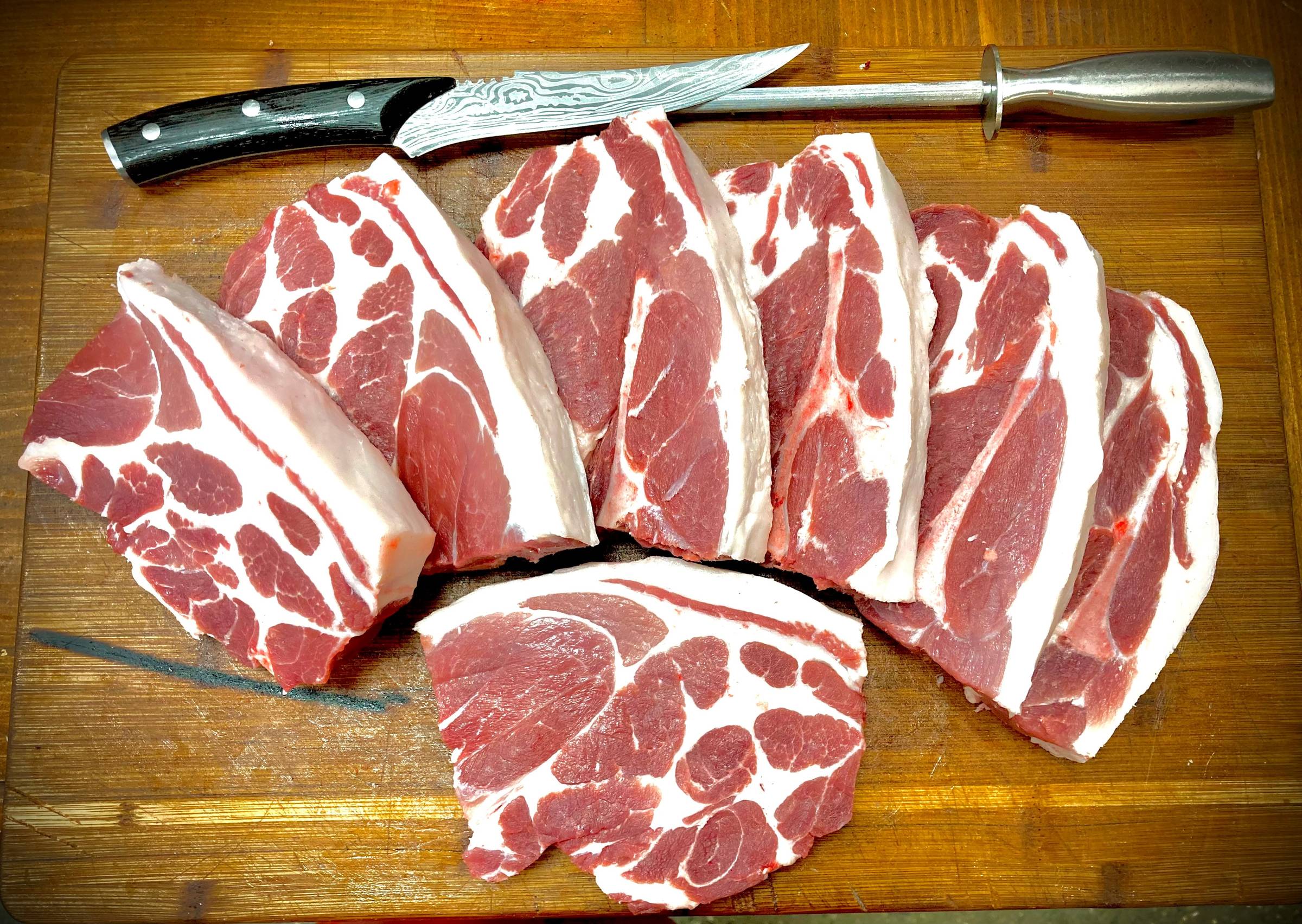 Pastured pork cuts on a wooden board