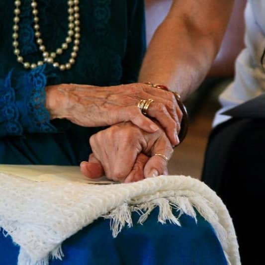 person wearing gold ring and blue dress