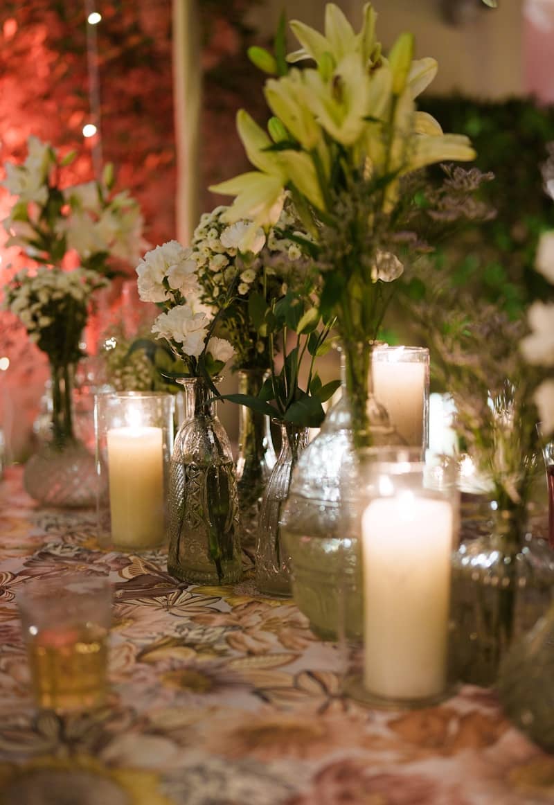 Flowers and candles adorn a festive table setting.
