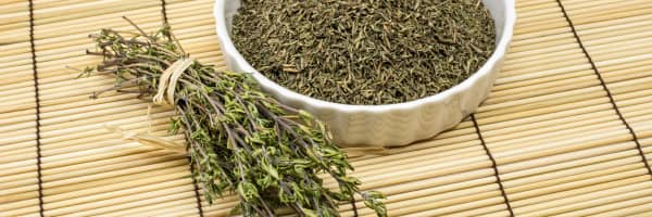 fresh thyme and dried thyme in a white bowl