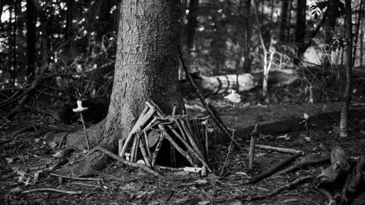 A black and white photo of a structure at the fairy village at Mackworth Island State Park