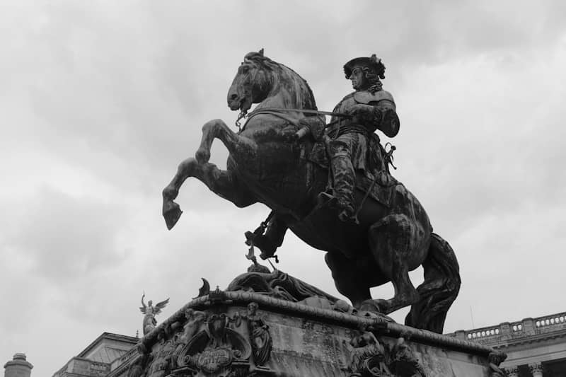 A horse and rider statue stands tall.