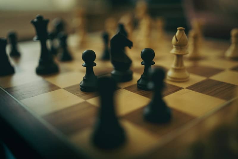 Chess pieces are set up on a chessboard.