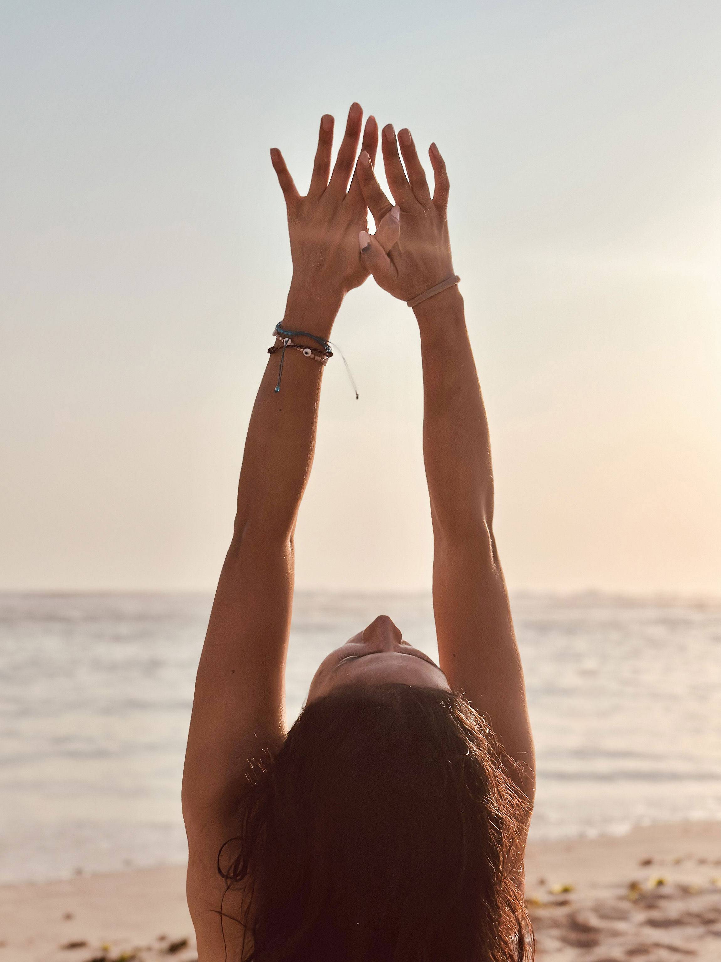 A woman stretching on a beach