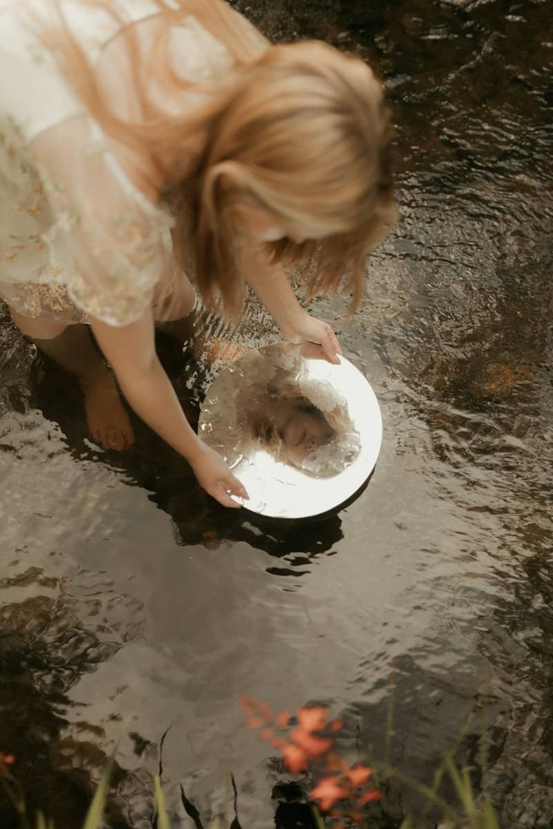 Woman looking at reflection in water
