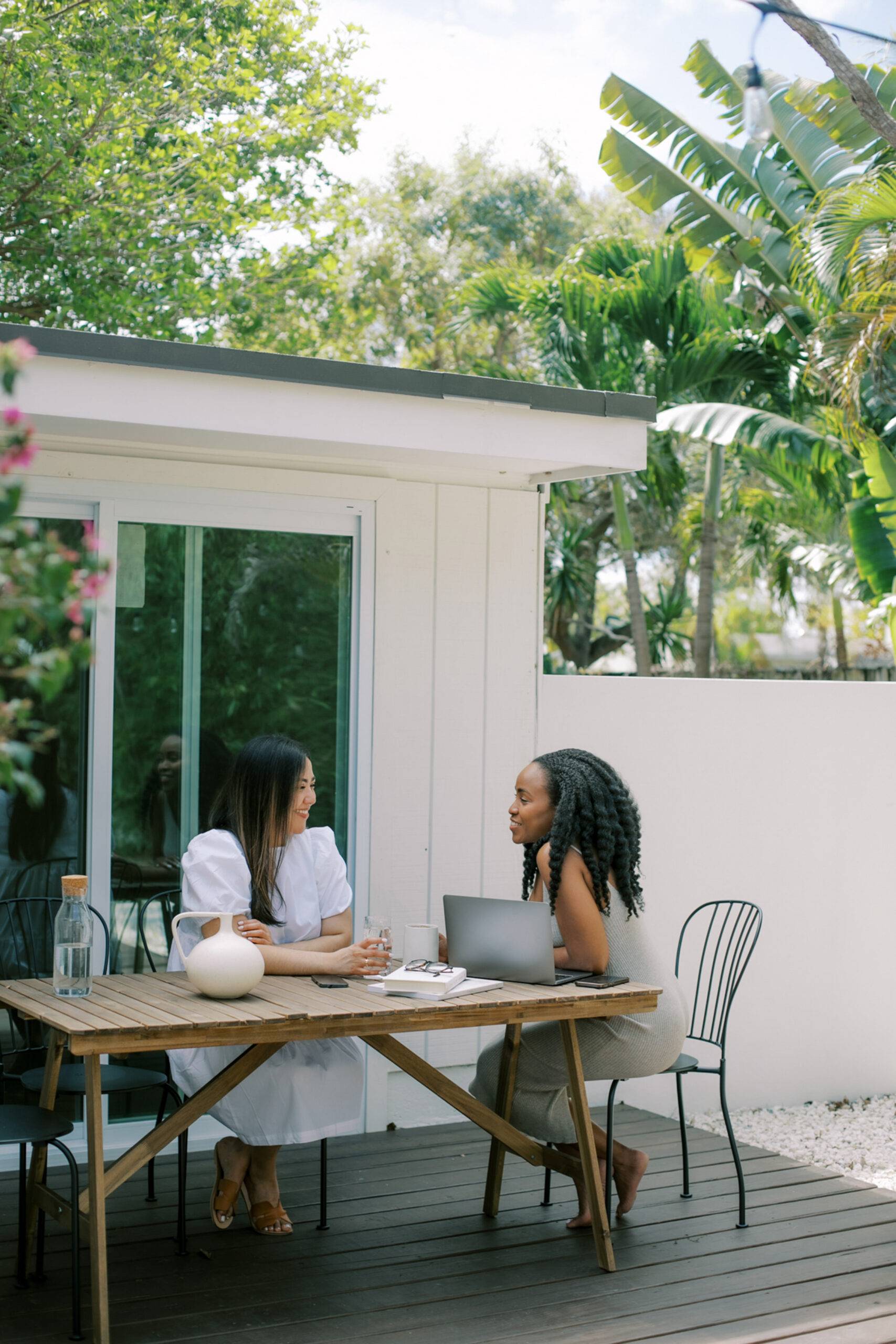 Two female friends chatting at a table