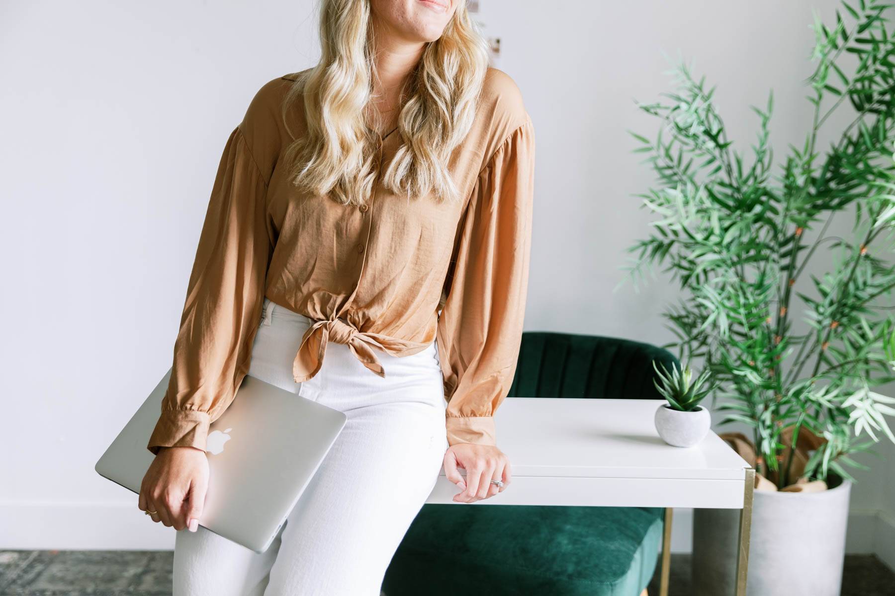 a woman leaning on a desk 