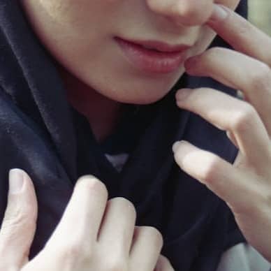 A person is touching their face.