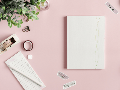 A fnotebok on a desk with little stickers that say "to do" "get it done'