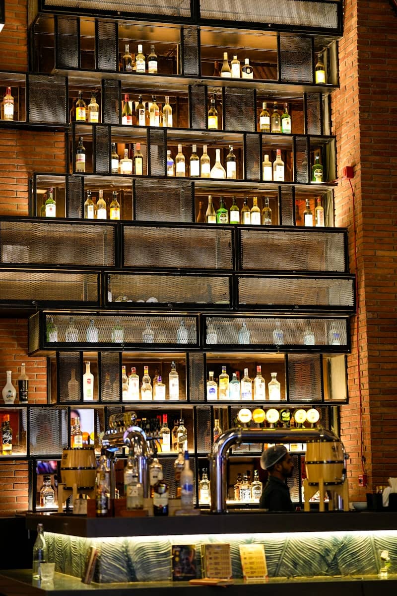 Bottles of alcohol displayed on shelves behind bar