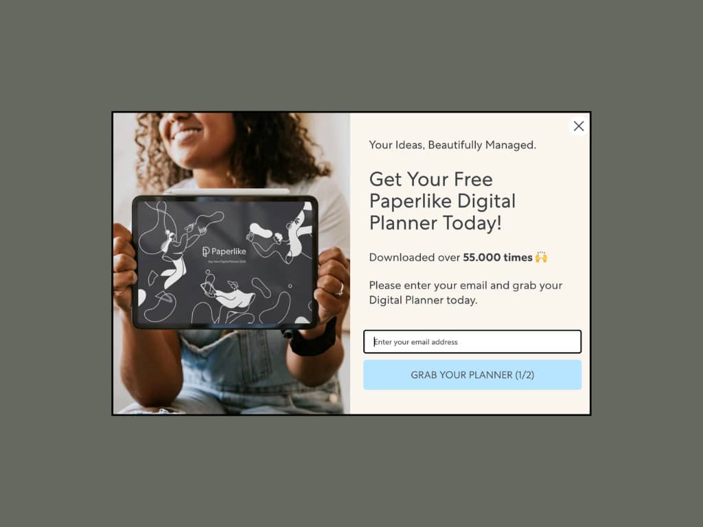 Paperlike popup offering free digital planner with 55,000 downloads stat and two-step indicator showing first of two screens.