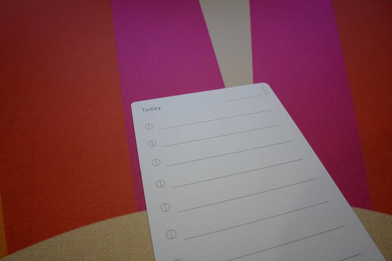 colored desk mat with a white paper to-do list card