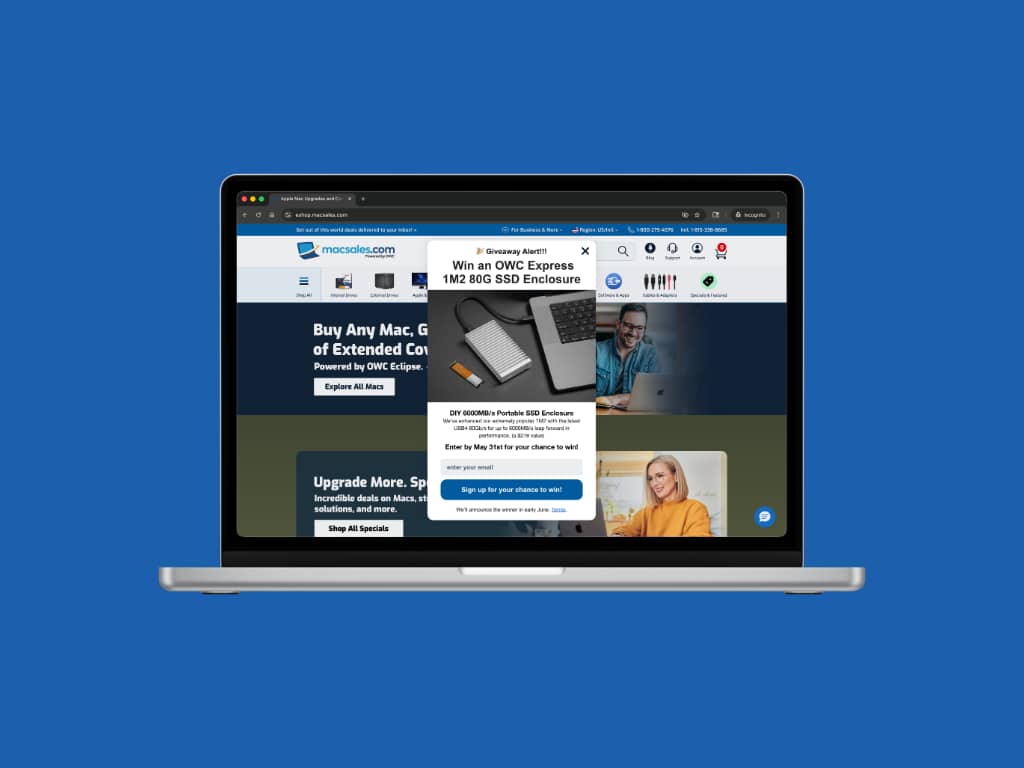 MacSales.com desktop homepage with giveaway popup overlaid, shown inside a MacBook Pro browser frame