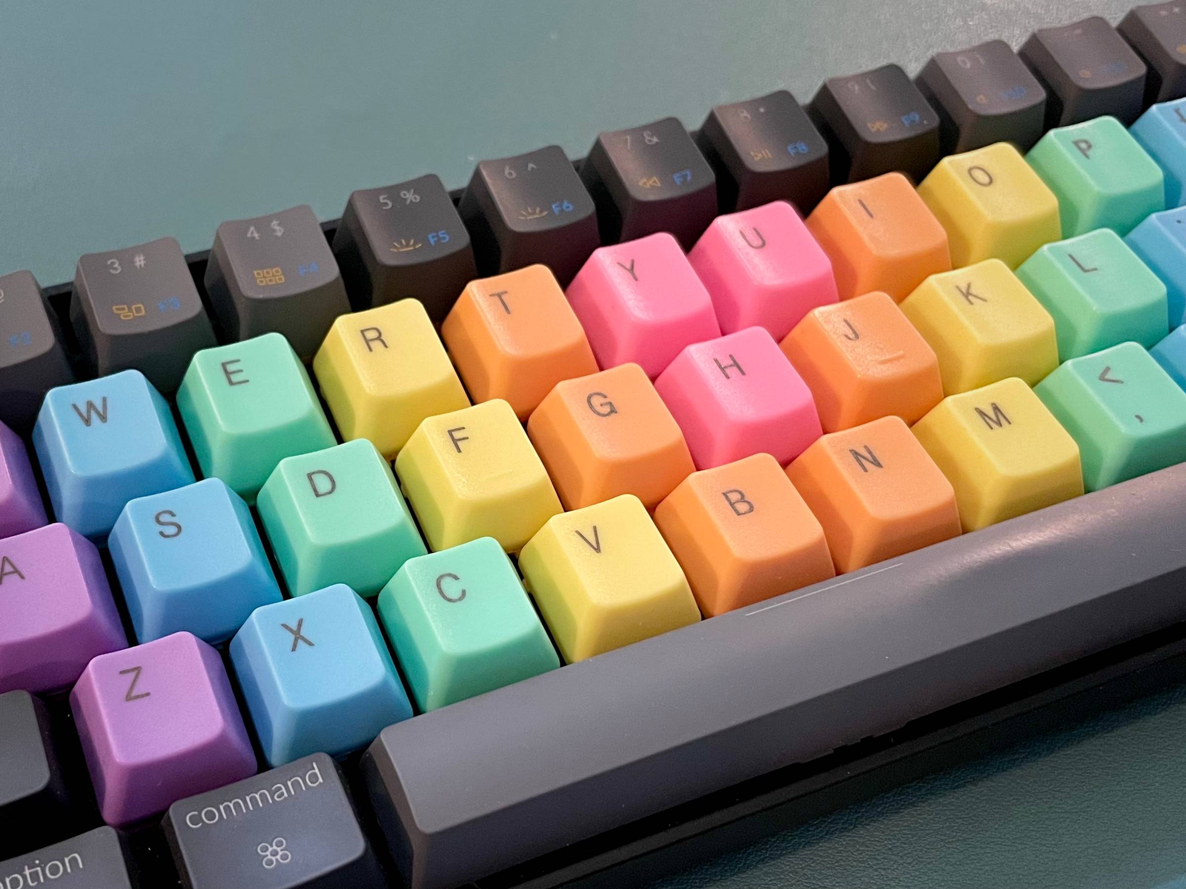 Keychron K6 keyboard with custom rainbow-colored keycaps in pastel tones