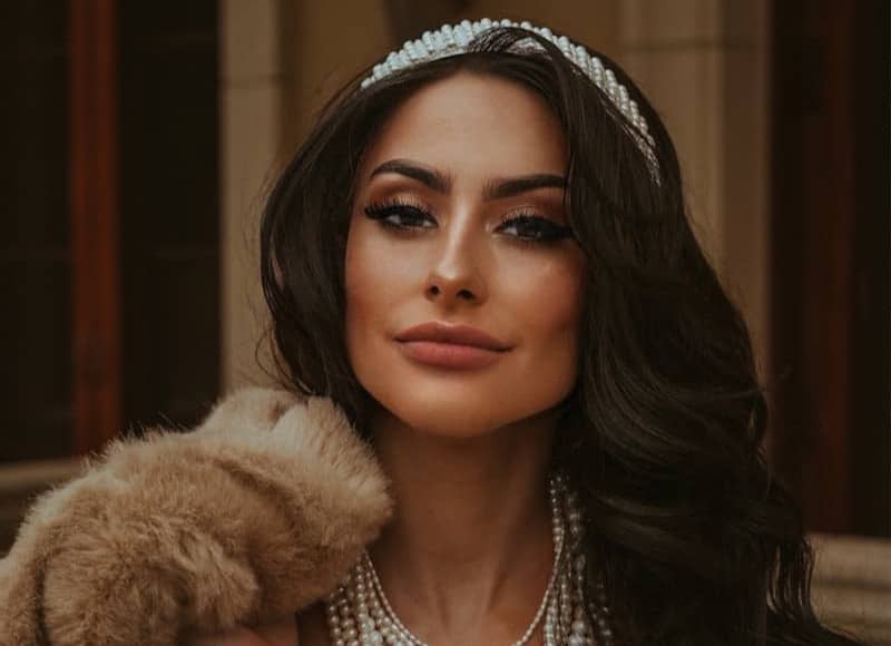 a woman wearing pearls and a tiara