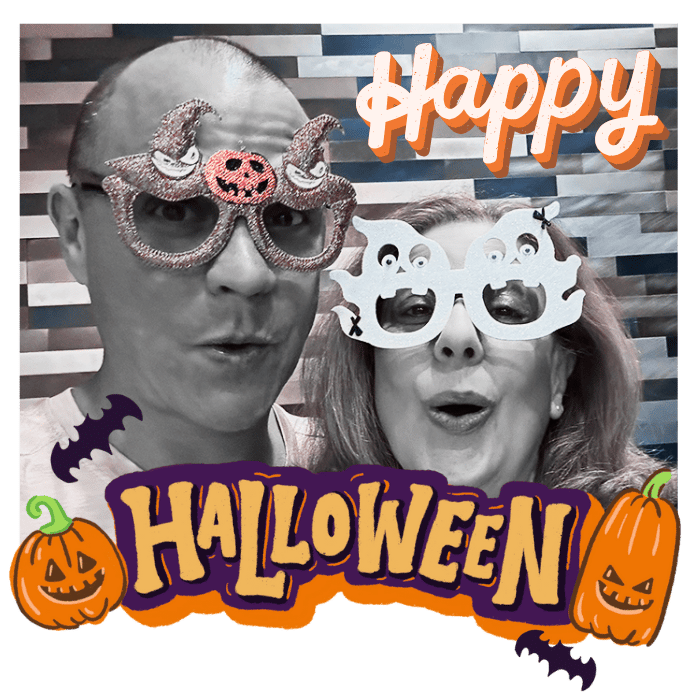 Julie and Brett. They are wearing halloween glasses. Brett's are witches hats and Julie's are ghosts. It reads: Happy Halloween