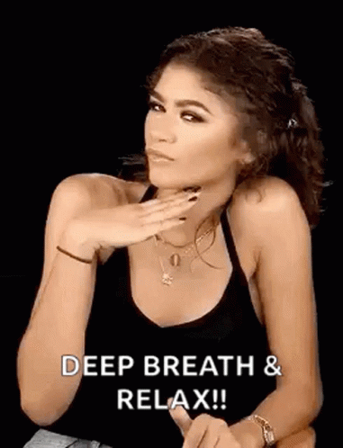 GIF of Zendaya gesturing to "Deep breath & relax!!"