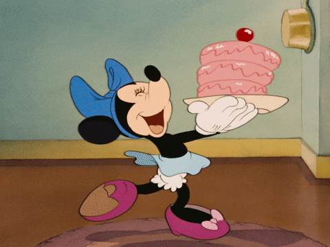 gif of Minnie Mouse skipping while c a cake on a platearrying