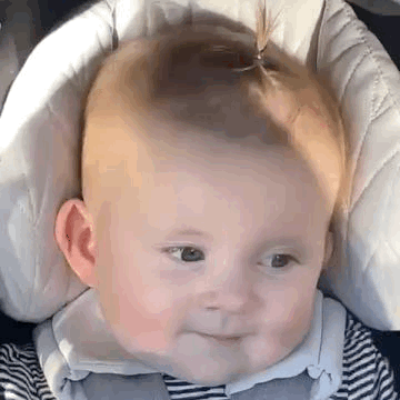 gif of a baby giving a coy sideways glance while turning their head