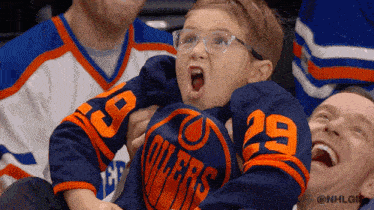 GIF of a highly excited young hockey fan