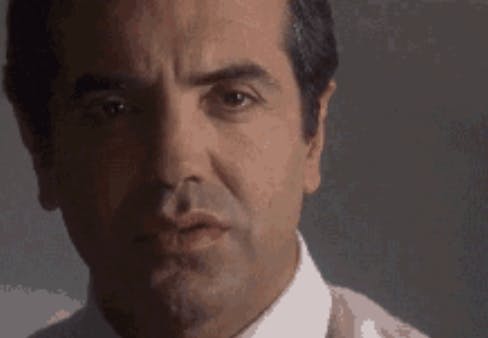 A close-up of the man in the GIF's shocked face