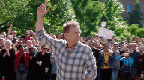 Phil Keoghan signaling the start of a season of The Amazing Race