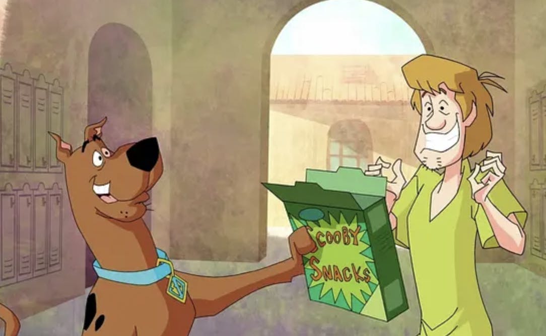 Scooby-Doo and Shaggy looking all excited over a box of Scooby Snacks