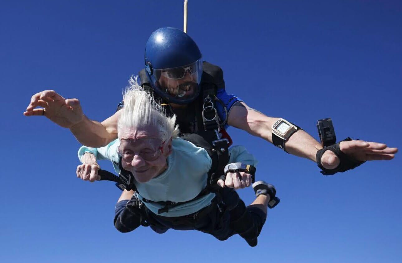 photo of an elder woman skydiving