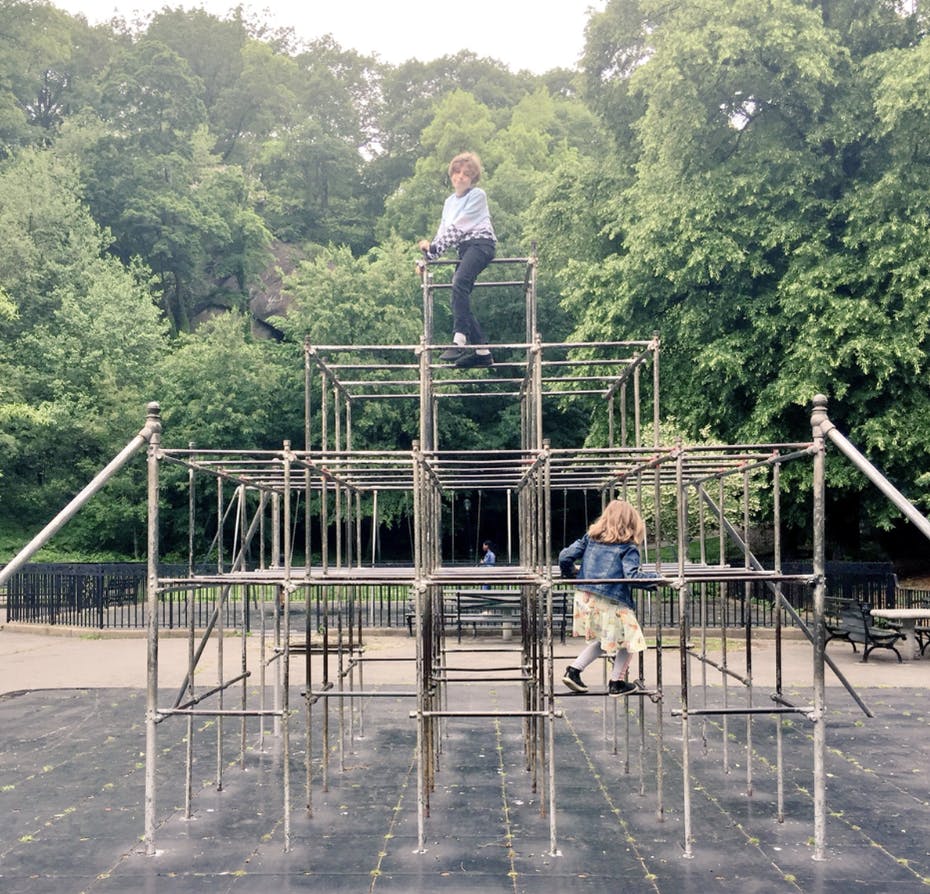 photo of retro playground equipment that involves a tall metal climbing structure