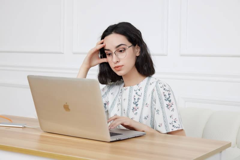 A woman sitting in front of a laptop computer