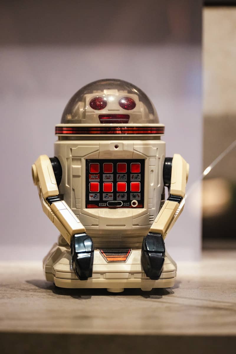 A toy robot sitting on top of a wooden table