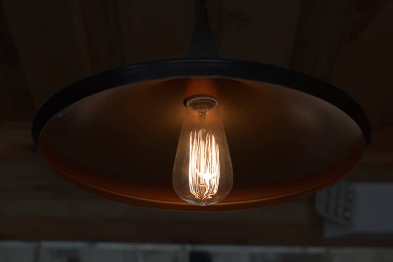 Edison light bulb hanging from a lamp.