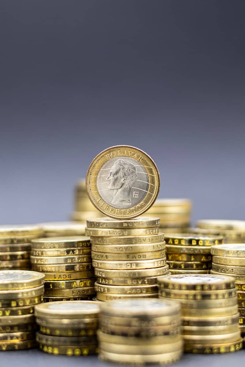 Stacks of gold coins with one coin on top