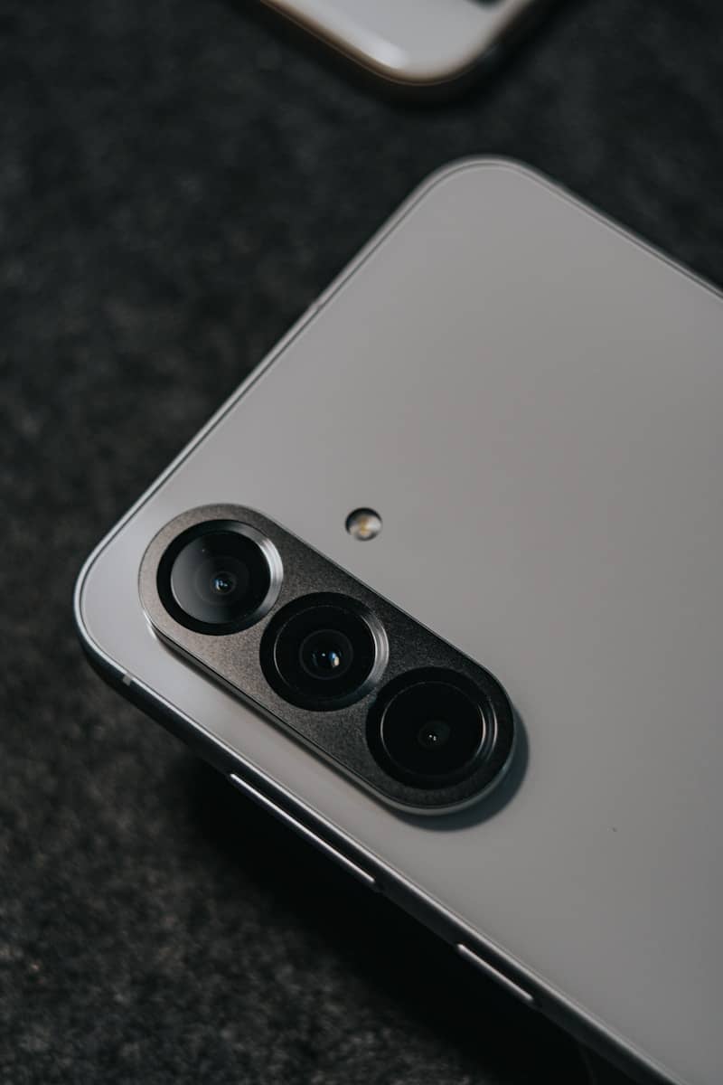 A smartphone features its triple-lens camera.