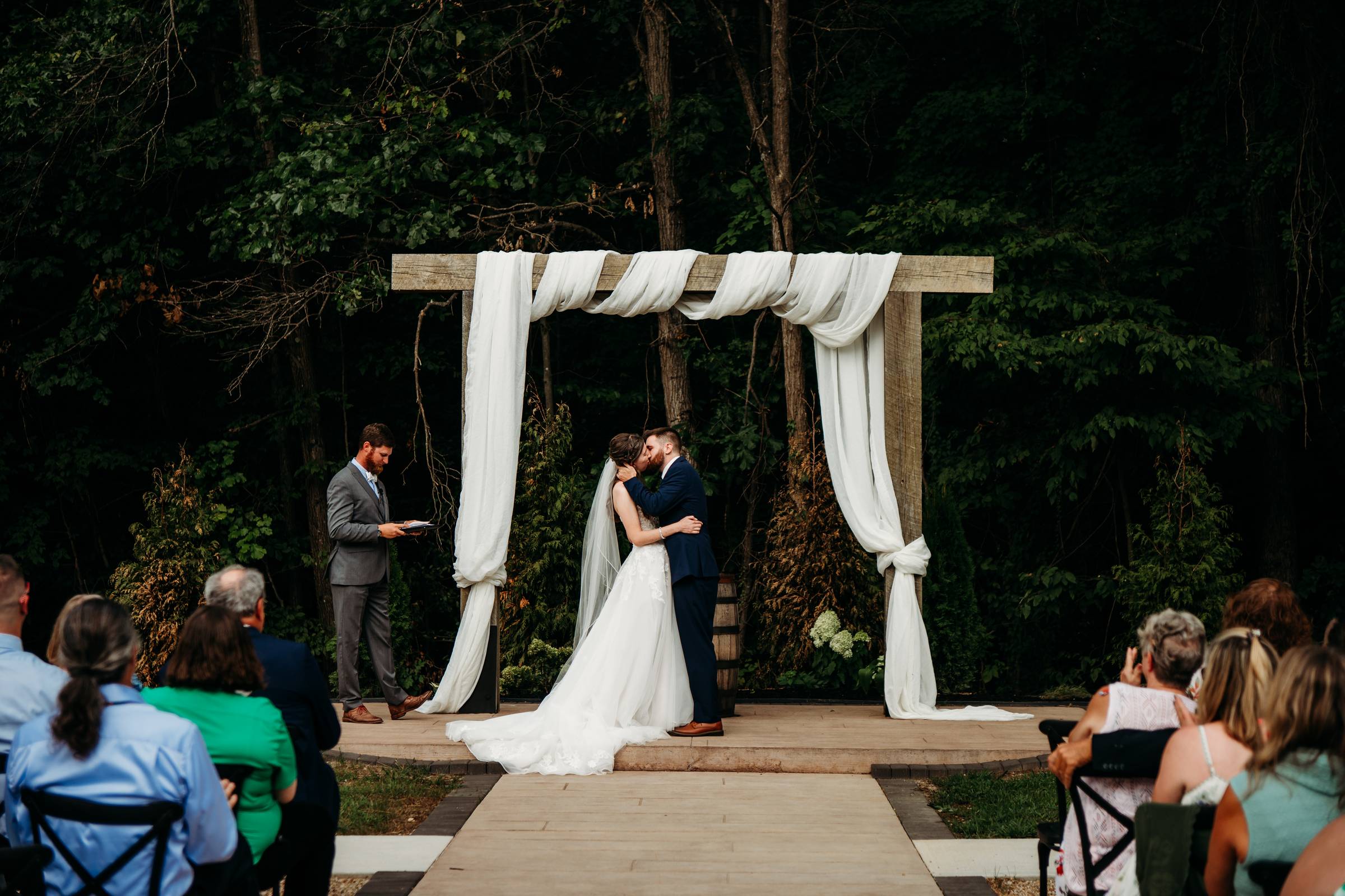 Newlyweds kiss in the aisle at The Reflection