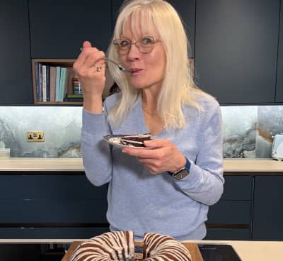 April Harris taking a bite of chocolate cake
