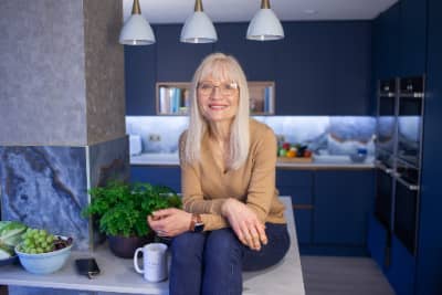 April J Harris sitting on the island in her kitchen