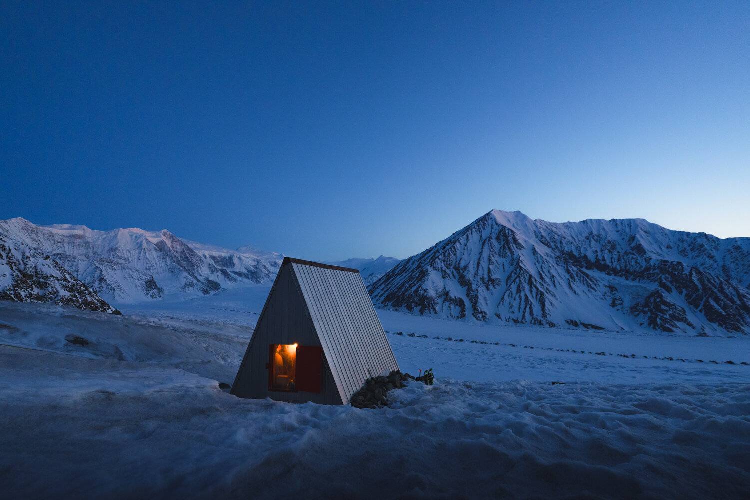a snowy landscape with a single house
