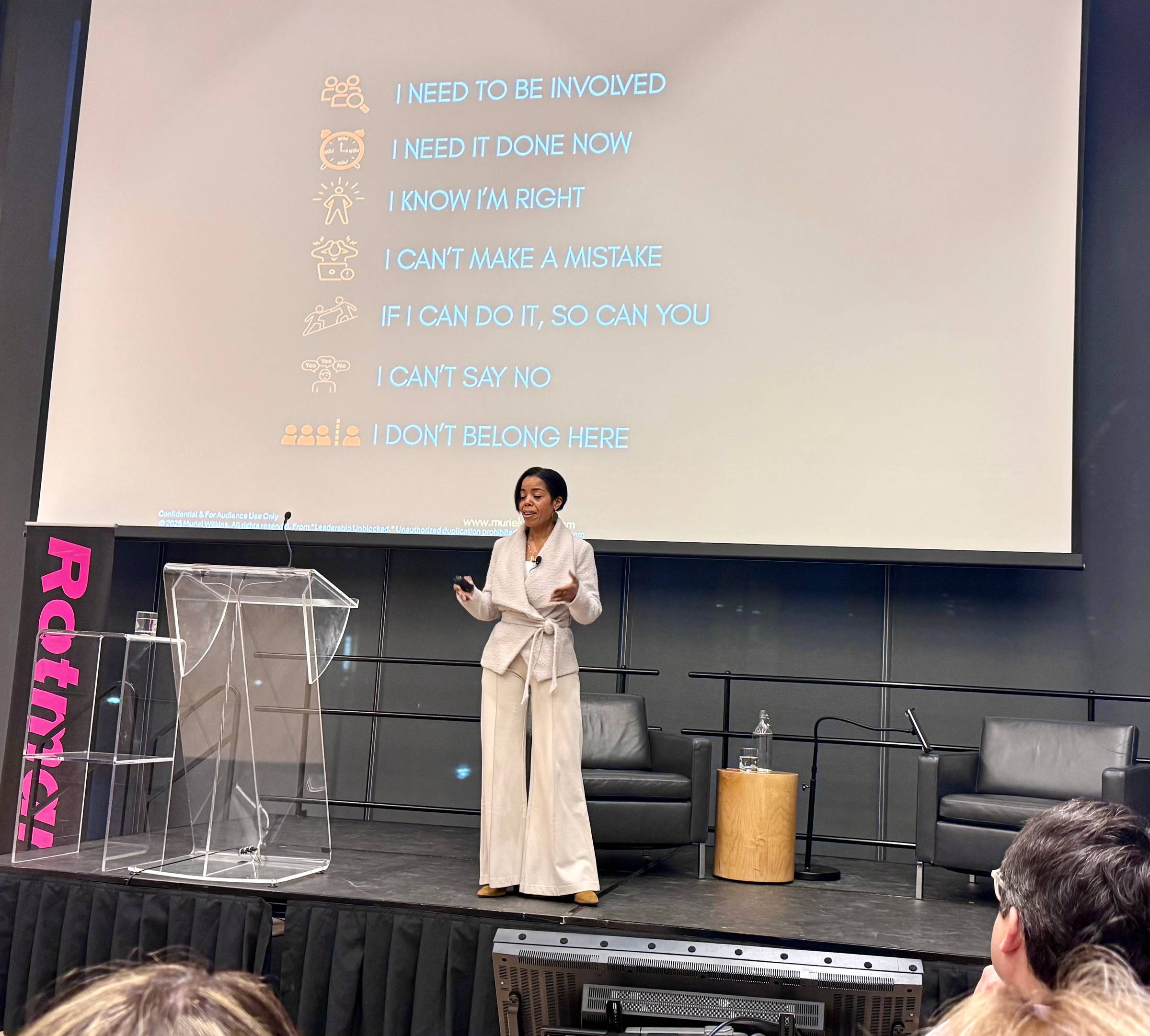 Author Muriel Wilkins on stage speaking about her book leadership unblocked