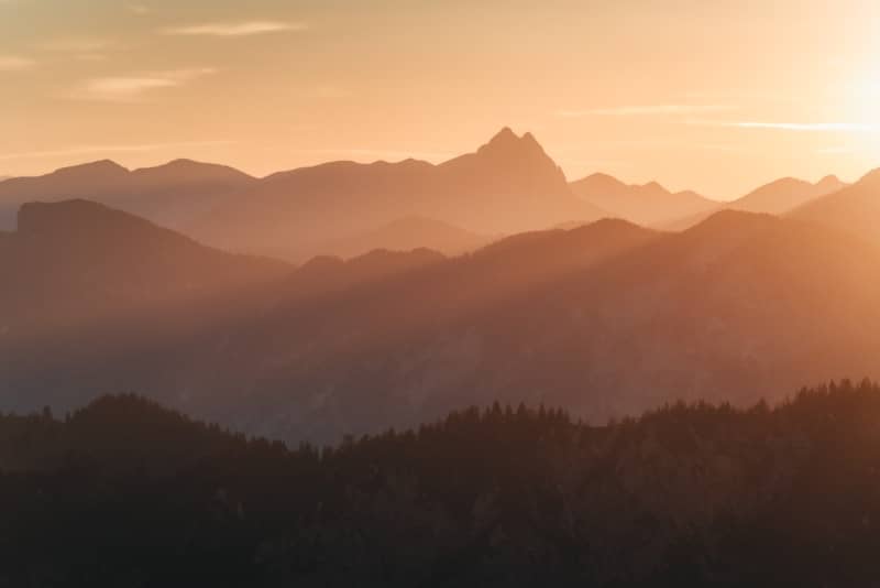 Hazy mountain range silhouette at sunset