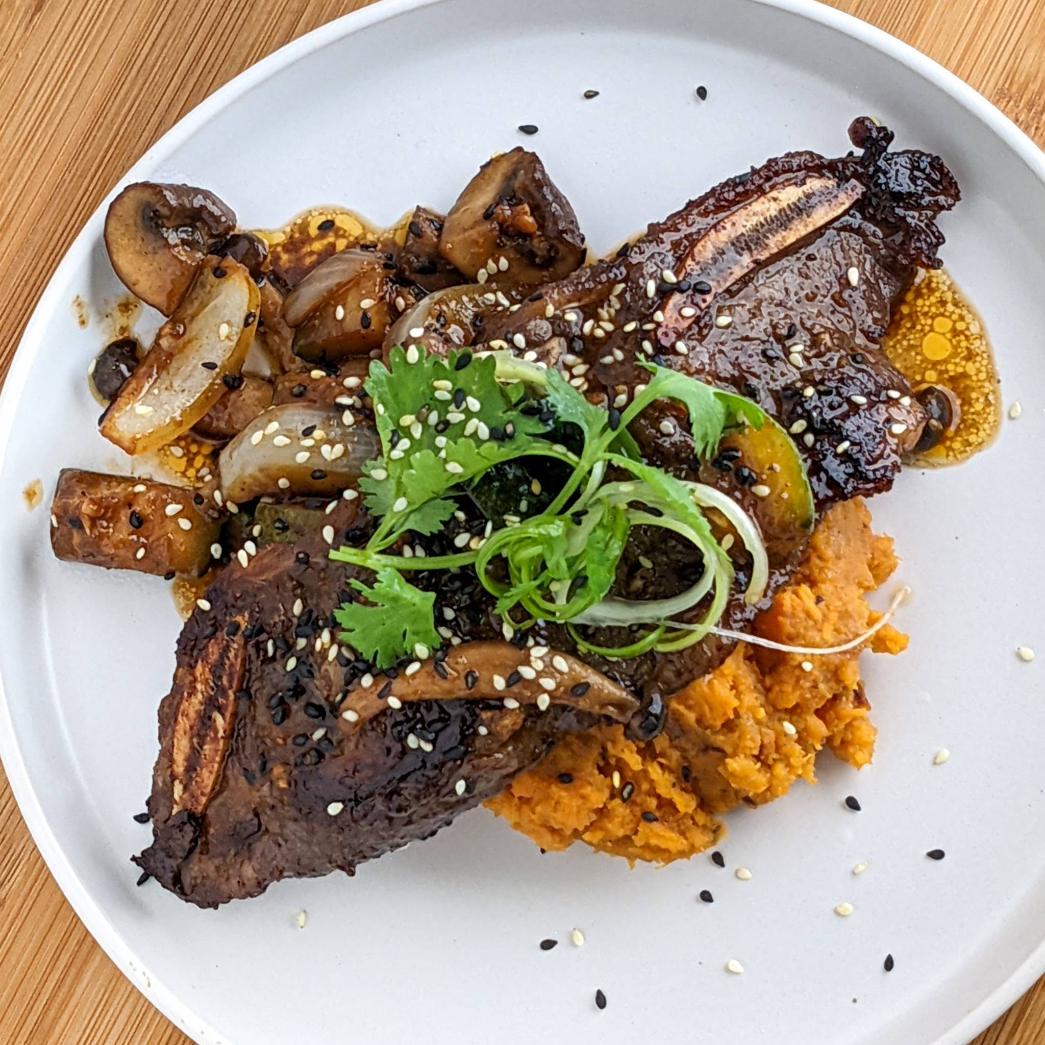 trader joe's korean short ribs plated with hot honey sweet mash potatoes and hibachi style vegetables.