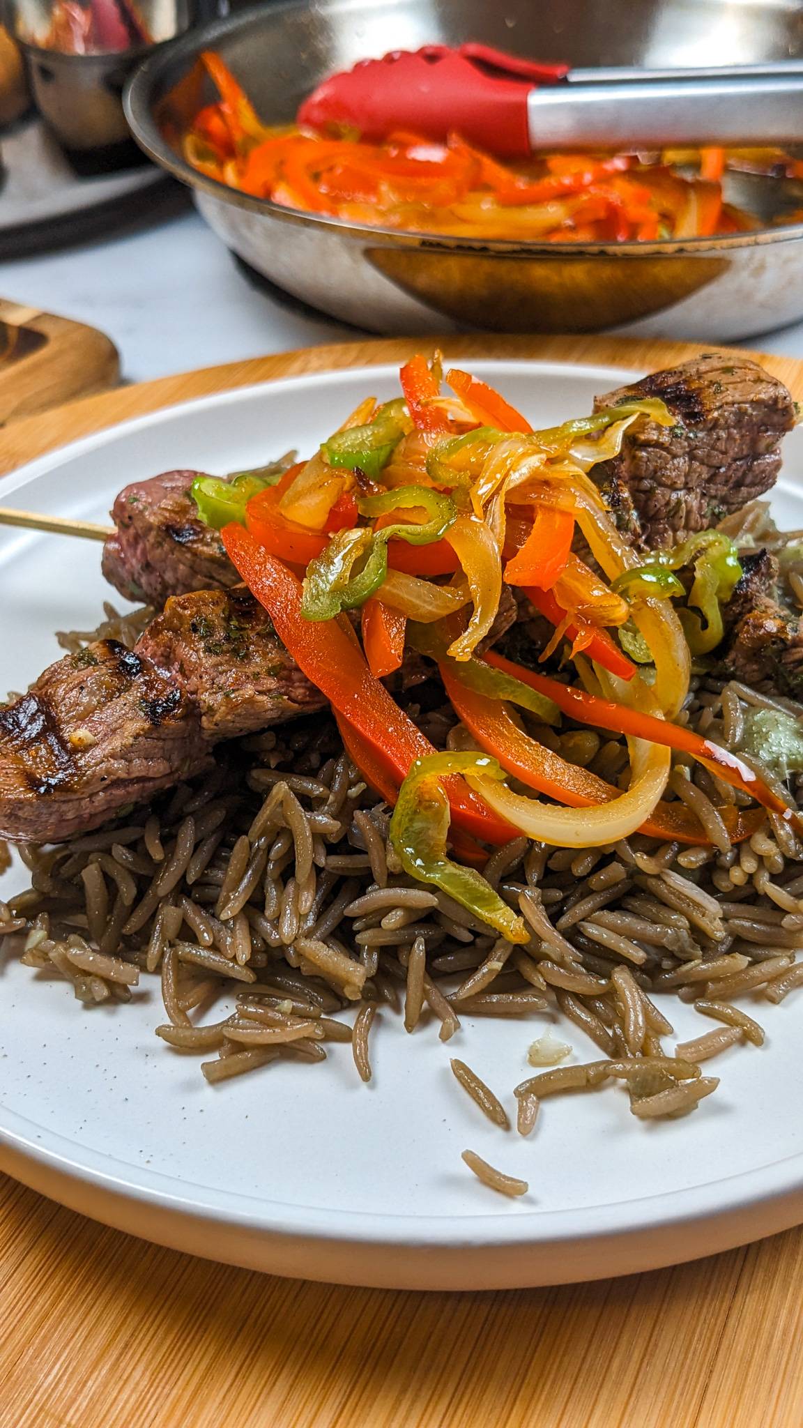 djon djon rice topped with grilled steak bites and escovitch.