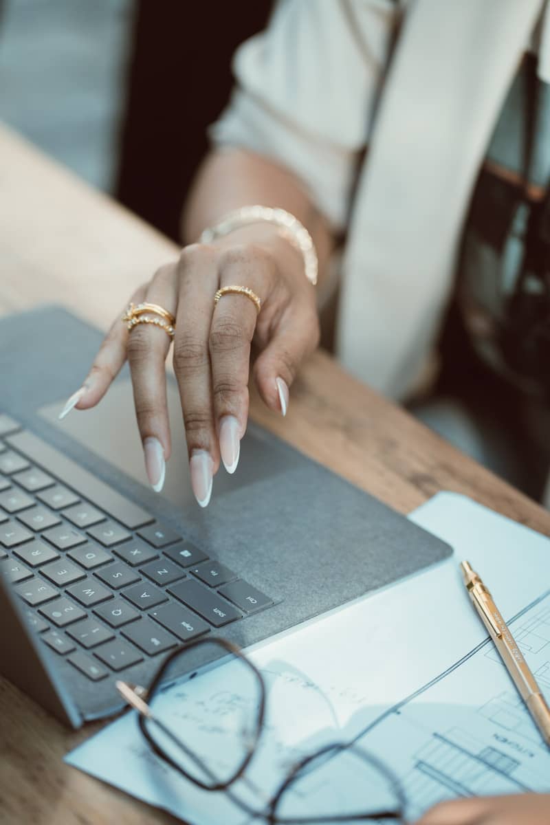 A woman sitting at a table with a laptop computer
