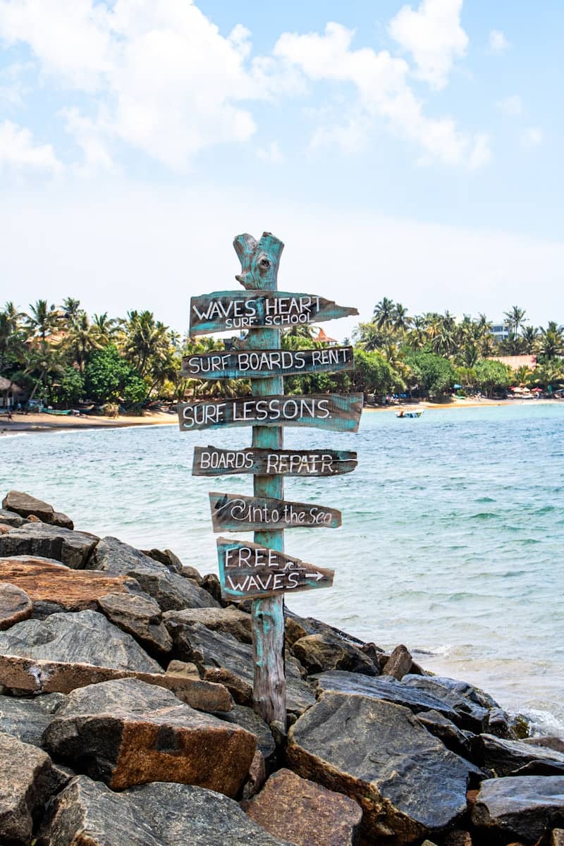 Signpost points toward surf lessons and rentals.