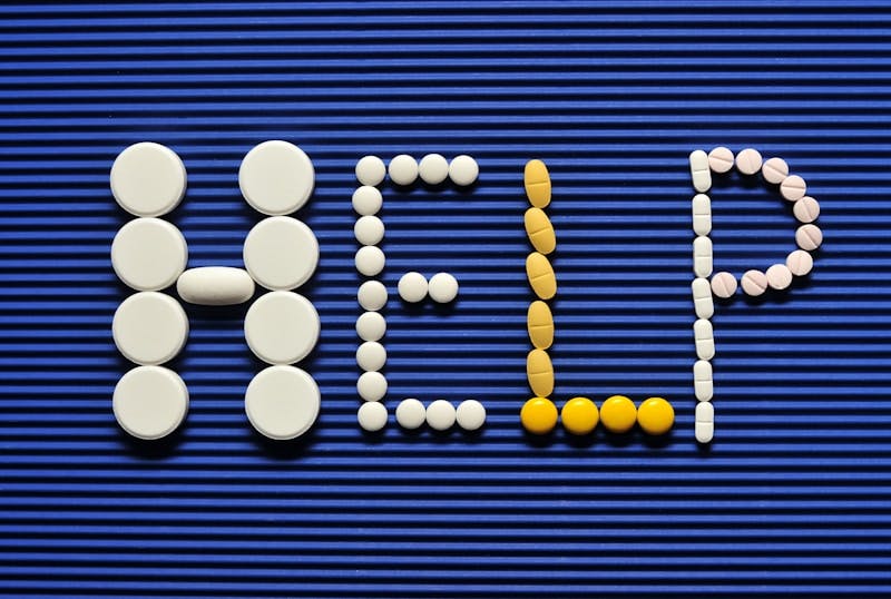 Pills spelling out the word pill pill on a blue background