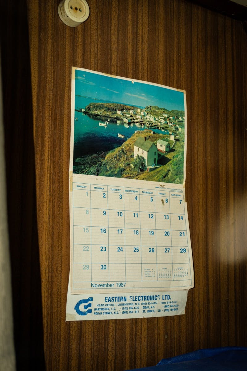 A calendar hangs on the wall of a room