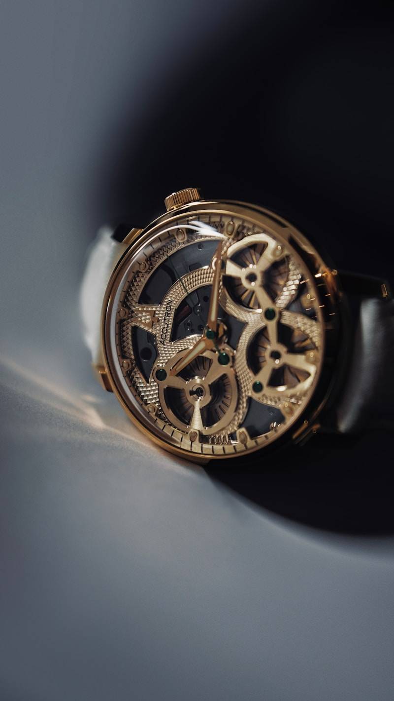 A luxurious, golden watch with an open mechanism.