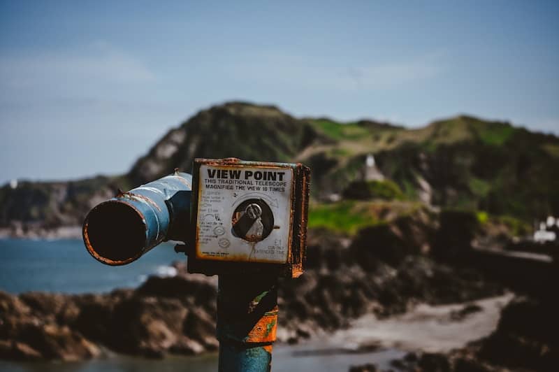 Viewpoint binoculars overlooking a scenic landscape.